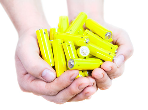Caucasian handful with lot penlight batteries isolated on white