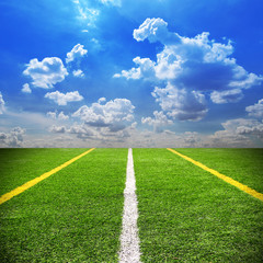 Football and soccer field grass stadium Blue sky background