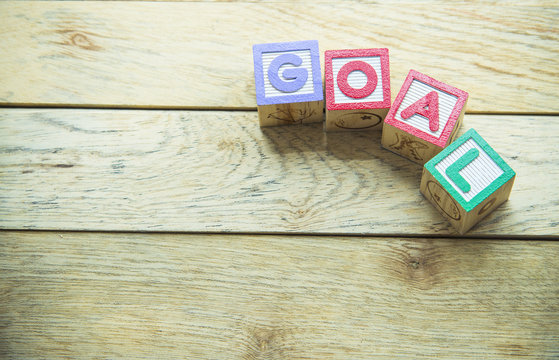 Wooden block word is GOAL on wooden background