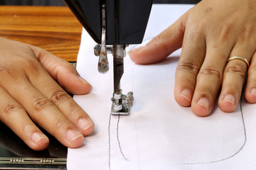 Woman hand, working with sewing machine