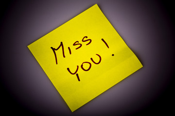 Yellow note paper miss you message