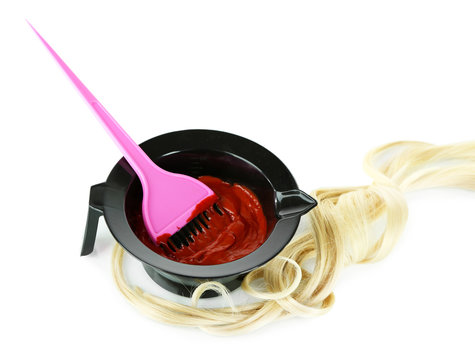 Bowl with hair dye and brush for hair coloring, isolated