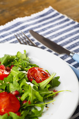 Green salad made with  arugula, tomatoes and sesame