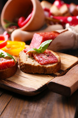 Composition with knife,  tasty sandwiches with salami sausage,