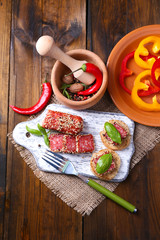 Composition with knife,  tasty sandwiches with salami sausage,