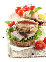 Delicious sandwiches with meet isolated on white