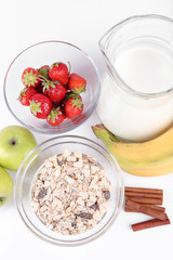 Healthy cereal with milk and fruits isolated on white