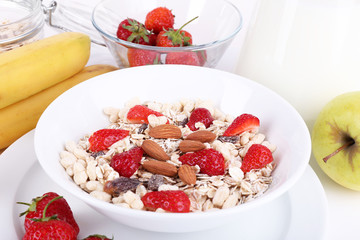 Healthy cereal with milk and fruits close up