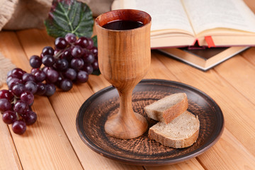 Cup of wine and bread on table close-up