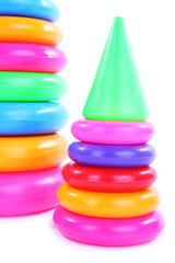 Plastic toy pyramids isolated on white
