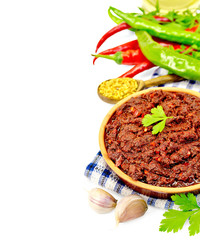 Adjika with hot pepper and spices on napkin