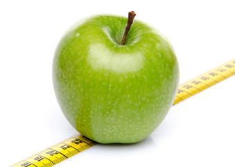 Green apple on a measuring tape