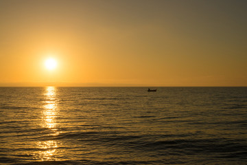Sunrise with fishing boat