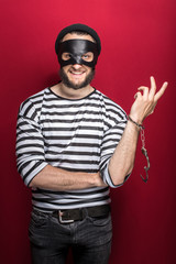 Fototapeta na wymiar Thief with handcuffs smiling