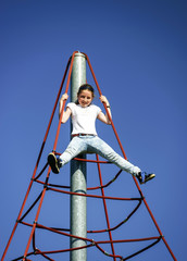 Teenage girl playing on child playground