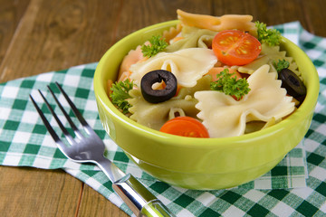 Delicious pasta with tomatoes on plate on table close-up