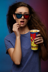 Obraz premium Beautiful girl watching movie with 3d glasses