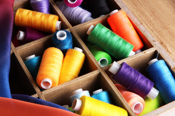 Multicolor sewing thread in wooden box,