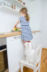 Little girl making meal in the kitchen.