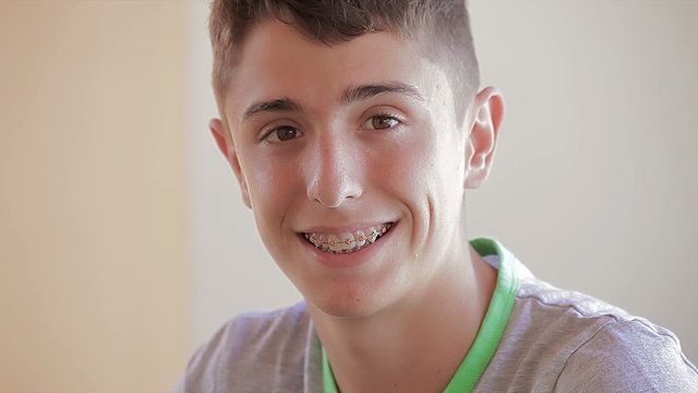 Teenager with dental appliance smiling and looking at camera
