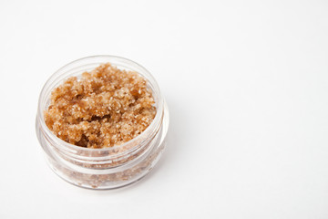 Homemade ginger lip scrub on white surface