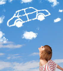 Young girl looking at car cloud on a blue sky