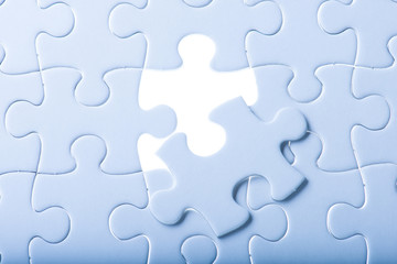 Missing jigsaw puzzle piece with light glow