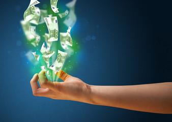 Glowing money in the hand of a woman