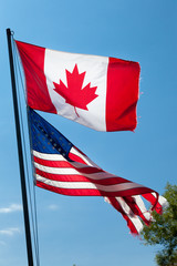 Low angle view of Canadian and American flags, Tobermory, Ontari
