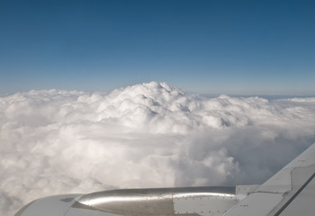 clouds through a window of a big jet plane