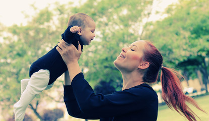 Portrait of happy loving mother and her baby outdoors