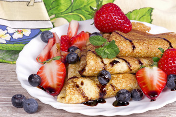 Pancakes with strawberries and blueberries