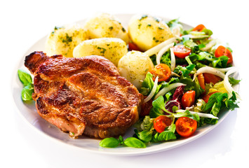 Grilled steak, boiled potatoes and vegetable salad