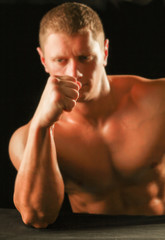 Fototapeta na wymiar Muscular man showing his strong biceps