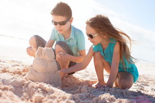 Two Kids Building Sand Castle