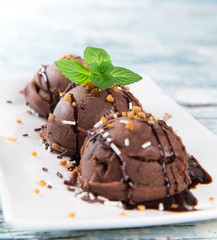 Ice cream scoops on wooden table.