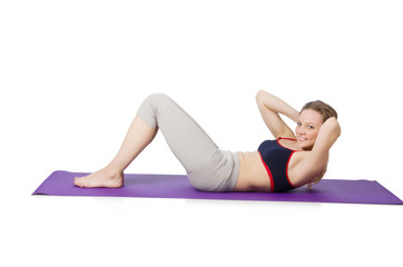 Young female doing exercises on white