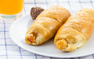 Chicken sausage roll on white plate