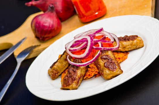 Cevapi with rice, ajwar and onion