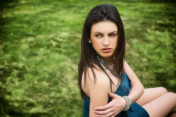 Fototapeta premium Attractive young woman in green grassland