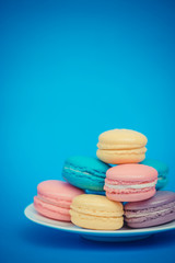 Sweet and colourful french macaroons on retro-vintage background