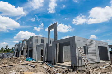 New home under construction against cloudy sky