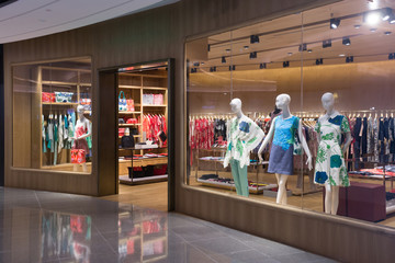 Boutique display window with mannequins in fashionable dresses