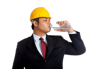 Asian engineer man drink water from a bottle