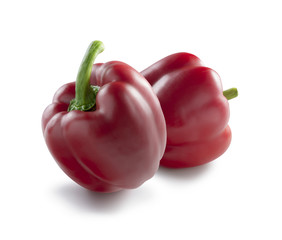 Two perfect red bell peppers on white background isolated