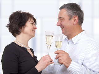 Man and woman celebrating with champagne