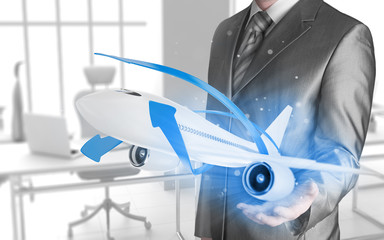 Businessman with airplane over his hand