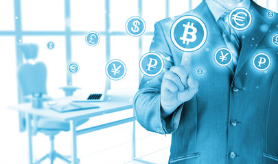 Choosing bitcoins, businessman pressing touch screen button.