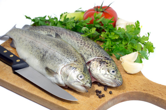 Fresh trout with parsley,garlic,tomato,pepper and knife