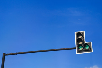 Green color on the traffic light with a beautiful blue sky in ba